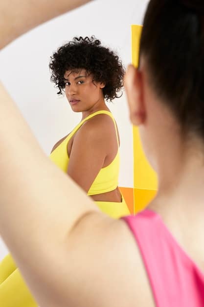 A person looking at themselves in a mirror after a workout, smiling confidently, showing the positive impact of exercise on self-esteem and body image.