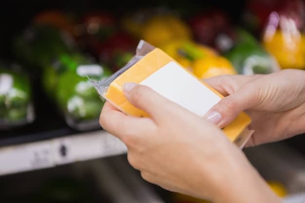 A hand pointing to the nutrition label of a packaged food item, highlighting the 