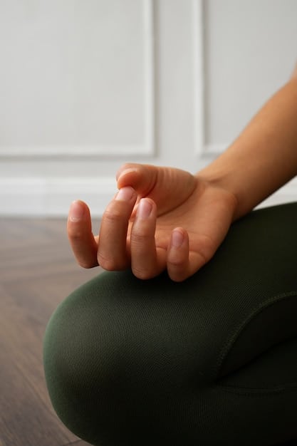 A close-up shot of a person's hands gently resting in their lap during meditation, symbolizing the stillness and focus of mindfulness practice.