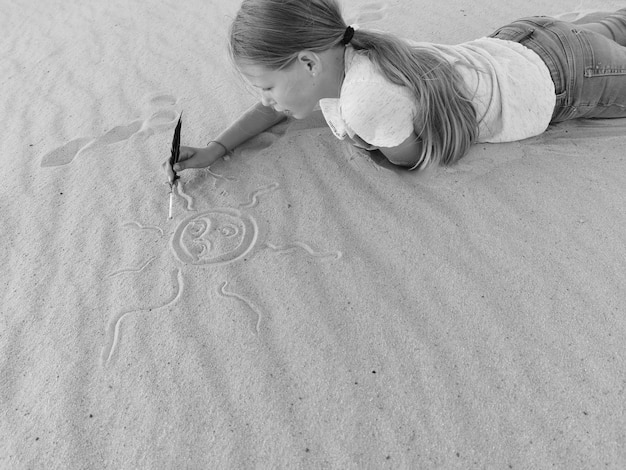 A person drawing a line in the sand with a determined expression, symbolizing setting boundaries. The background depicts a peaceful beach scene.