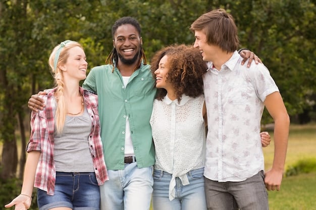 A group of smiling people hugging and showing appreciation for each other in a sunny park. The scene is genuine and heartfelt.