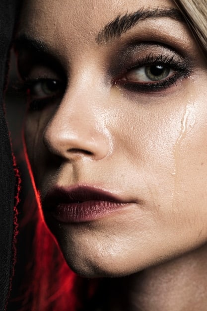 A close-up of a person's face, partially obscured, with a single tear running down their cheek. The image captures the raw emotion and sadness associated with depression, emphasizing the internal struggle.