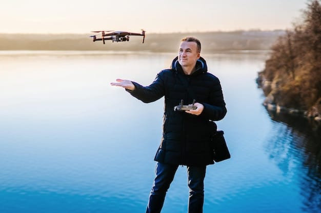 A drone pilot, wearing a headset and holding a remote controller, standing in an open field with a drone hovering in the background. The pilot is focused and appears to be monitoring the drone's flight.