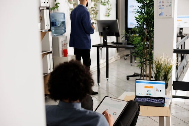 A modern office space with employees working, emphasizing the importance of tracking and managing business expenses.