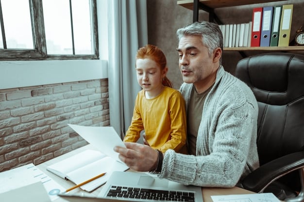 A father, a business owner, sitting at his desk alongside his son, reviewing financial documents and charts together, symbolizing the act of mentoring and preparing the next generation for leadership in business succession planning.