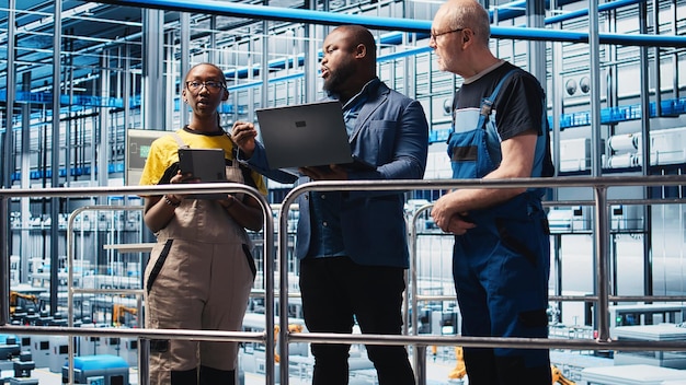 A diverse group of engineers and technicians working on 5G network equipment in a high-tech laboratory setting. The focus is on collaboration and innovation, with data visualizations and network diagrams displayed on large screens in the background.
