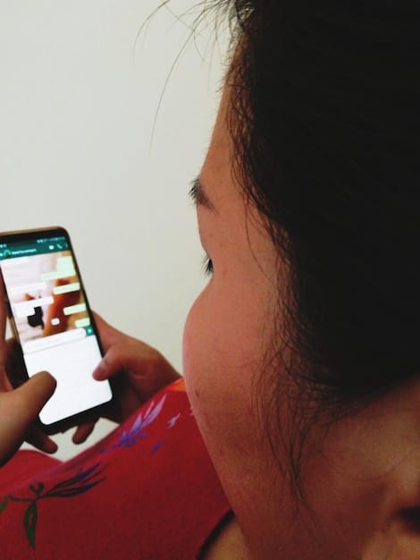 Close-up of a person's eye, looking anxiously at a phone screen displaying numerous social media notifications. The reflection in the eye shows various social media icons, symbolizing the overwhelming nature of social media.