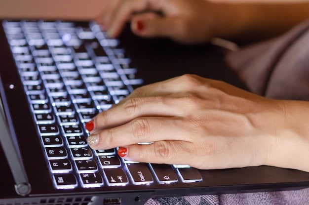 A close-up shot of a person's hands typing on a keyboard, with a concerned expression on their face, symbolizing the stress and pressure experienced in many modern workplaces. The background is blurred to emphasize the focus on the individual's experience.
