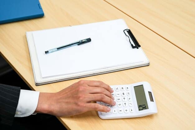 A close-up shot of a professional hand using a calculator, with a financial document lying nearby. The calculator display shows a complex equation with numbers and symbols. The financial document has charts and graphs indicating financial performance. The setting is a well-lit, modern office environment.