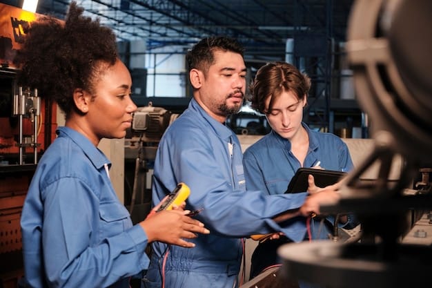 A diverse group of technicians in a training session, learning to program and maintain industrial robots in a modern US manufacturing training center.